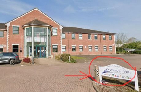 Photograph of cotswold house including a sign, highlighted, stating that it's run by WVHT