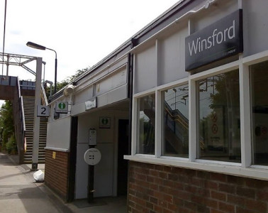 A photograph taken looking along the platform, with the station name "Winsford" visible